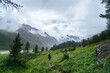 © Ivan Ozerov/Stocksy - Lonely hiker walking on mountain valley