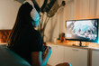 © Tadeu Dreyer/Stocksy - Unrecognizable woman gaming at home