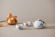 Tea Concept With White Tea Set Of Cups And Teapot Surrounded