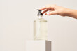 © 365mm/Stocksy - Crop female showing bottle with soap