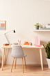 © 365mm/Stocksy - Chair and table against beige wall