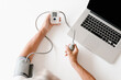 © Alina Hvostikova/Stocksy - Crop pensioner measuring blood pressure over table with laptop