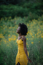 Portrait Of A Young Black Woman In A Yellow Flower Field