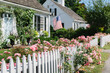 © Raymond Forbes Photography/Stocksy - Summer Roses on White Picket Fence in New England