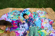 © Lauren Lee/Stocksy - Happy kids with tie-dye shirts