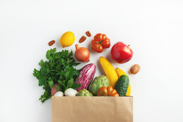 Wall Mural - Healthy food background. Healthy vegan vegetarian food in paper bag vegetables and fruits on white, copy space. Shopping food supermarket and clean vegan eating concept