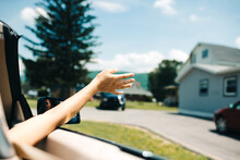 Girl Holding Hands Out Of The Car While Driving Free And Wild