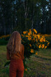 © Danil Nevsky/Stocksy - Unrecognizable woman with flowers in countryside