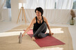 © Sibstock/Stocksy - woman resting on yoga mat after sports