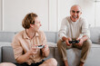 © Alina Hvostikova/Stocksy - Aged man with son enjoying video game at home