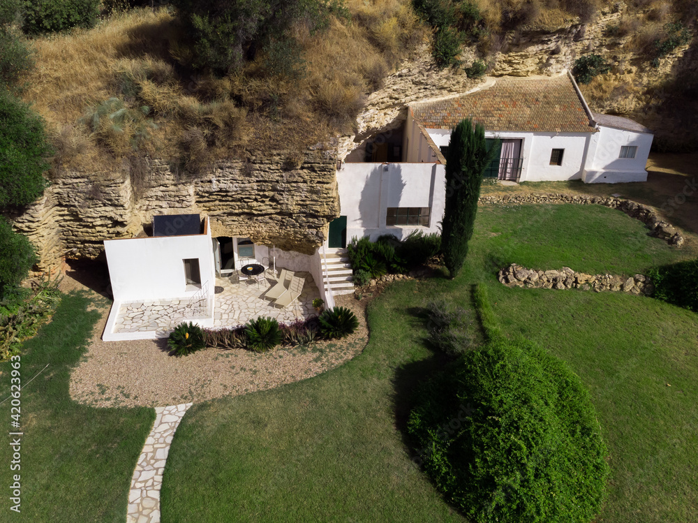 Hoconstruction Inside Rocks Exterior of residential house built into rock Stock Photo | Adobe Stock