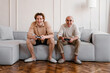 © Alina Hvostikova/Stocksy - Aged man with son enjoying video game at home