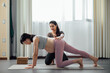 © MaaHoo Studio/Stocksy - Pregnant woman doing yoga in studio