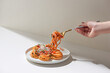 © Maki Company Limited/Stocksy - Fresh bite of hot spaghetti wrapped on fork against bright background. Shallow depth of field.