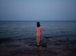 © ZHPH Production by Artem Zhushman/Stocksy - Portrait back woman sea