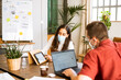 © Malquerida Studio/Stocksy - Focused female and man freelancer working at office wearing protective face mask due to the coronavirus