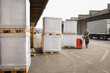 © Jelena Jojic Tomic/Stocksy - One man operates the pallet jack in front of a warehouse full of shipping goods