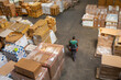 © Jelena Jojic Tomic/Stocksy - One man operates the pallet jack in a warehouse full of shipping goods