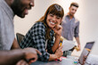© MyMicrostock/Stocksy - Multiethnic group of business people working in an office