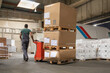 © Jelena Jojic Tomic/Stocksy - One man operates the pallet jack in a warehouse full of shipping goods