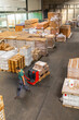 © Jelena Jojic Tomic/Stocksy - One man operates the pallet jack in a warehouse full of shipping goods