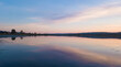 © Danil Nevsky/Stocksy - Cloudy sundown sky reflecting in calm lake