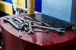 © David Prado/Stocksy - Wrenches and keyboard on table