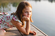 © Michela Ravasio/Stocksy - Little girl with red hair looking at the landscape