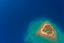 Aerial View If Tiny Island In Turquoise Sea