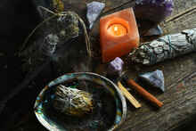 A Close Up Image Of A Burning White Sage Smudge Stick And Healing Crystals. 