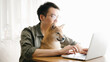 © JIACHUAN LIU/Stocksy - Working at home with pet dog