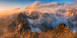 © plpictures by Paedii Luchs/Stocksy - Man standing on swiss alpine ridge sunset panorama