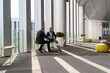 © Hernandez & Sorokina/Stocksy - Businessmen Having Conversation At Office Terrace