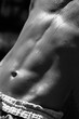 © Sonja Lekovic/Stocksy - male abs black and white