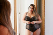 © Ivan Gener/Stocksy - Smiling full-figured woman wearing lingerie