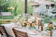 © Adrian Cotiga/Stocksy - Table setting decorated with pastel flowers and candles