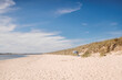 © Sturmsucht/Stocksy - Sandy beach with parasol on sunny day