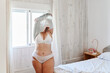 © Ivan Gener/Stocksy - Full-figured woman undressing in her bedroom
