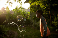 Boy Watching As Huge Bubble Pops