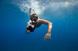 © Jovana Milanko/Stocksy - Man filming with action cam underwater