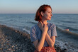 © Lyuba Burakova/Stocksy - Woman enjoys sunset at the seaside