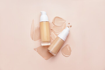 Wall Mural - Bottles of makeup foundation and samples on color background