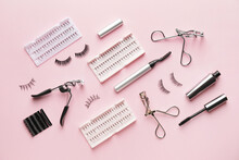 Composition With False Eyelashes And Tools On Color Background