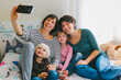 © MyMicrostock/Stocksy - Happy lesbian family taking selfie at home