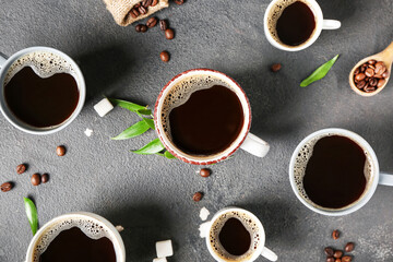 Cups of hot coffee on dark background