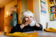 © MyMicrostock/Stocksy - Little child drinking milk during breakfast