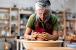 © Nunez Image/Stocksy - Woman Making Pottery On Spinning Wheel