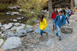 © Bisual Studio/Stocksy - Group of friends trekking in an autumnal forest