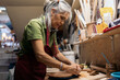 © Nunez Image/Stocksy - Woman Working in Pottery Workshop
