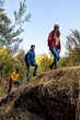 © Bisual Studio/Stocksy - Three friends Walking through the mountain in autumn